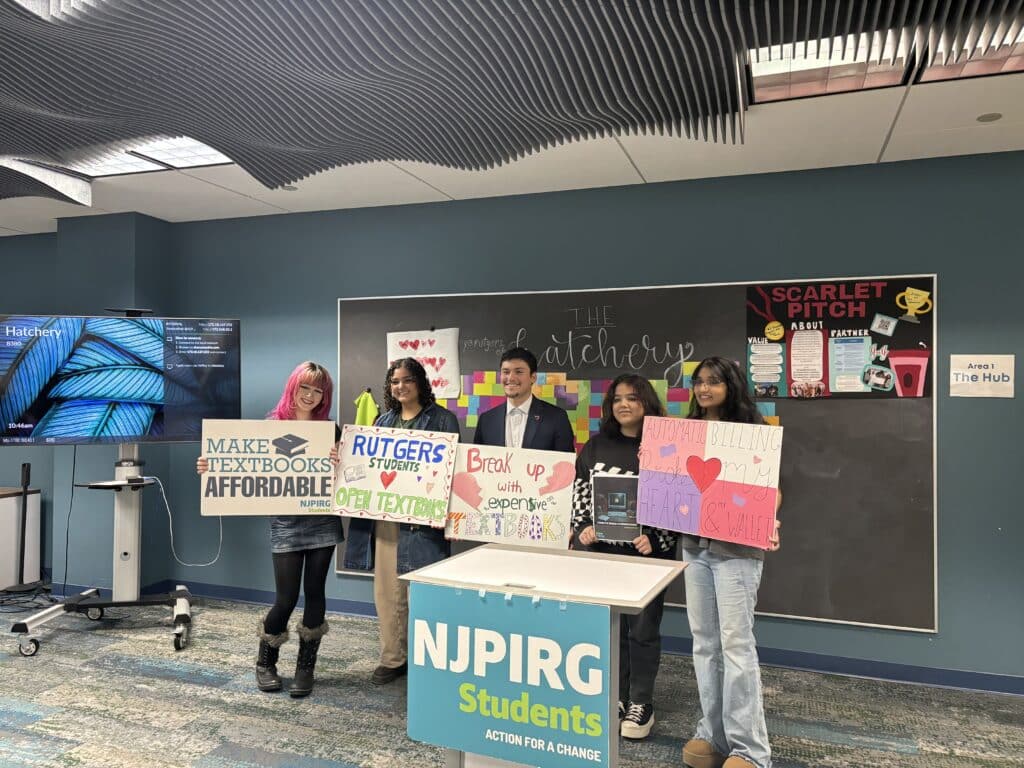 Students at the NJPIRG press conference holding signs supporting the open textbooks initiative.