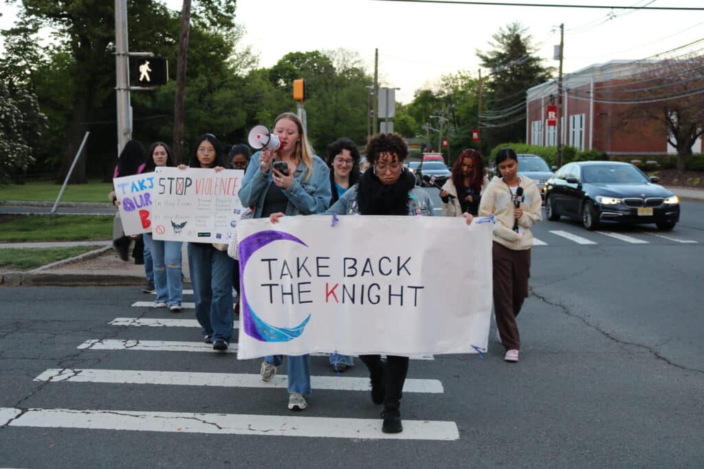 Attendees with posters march down George Street for the annual Take Back the Night